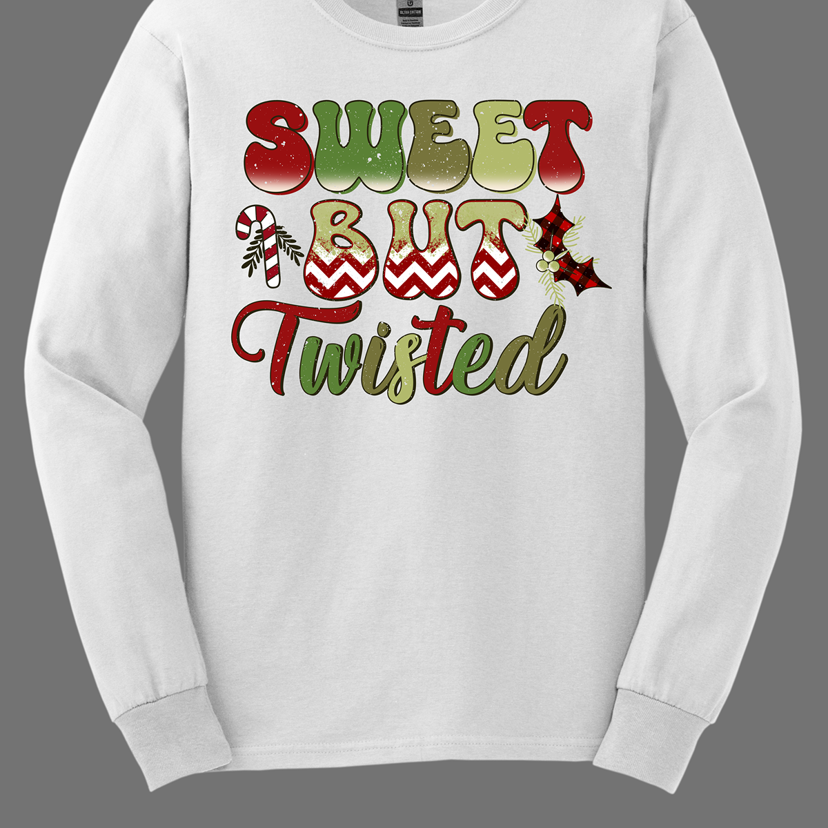 The apparel features a playful and bold design with the phrase "Sweet but Twisted" prominently displayed in large bubble letters. The letters are vibrant, with shades of green and red, creating a fun, festive contrast. The word "but" stands out, with its bottom edges filled with a red and white chevron pattern, adding a striking visual detail. Shop at Gorgeousware.com