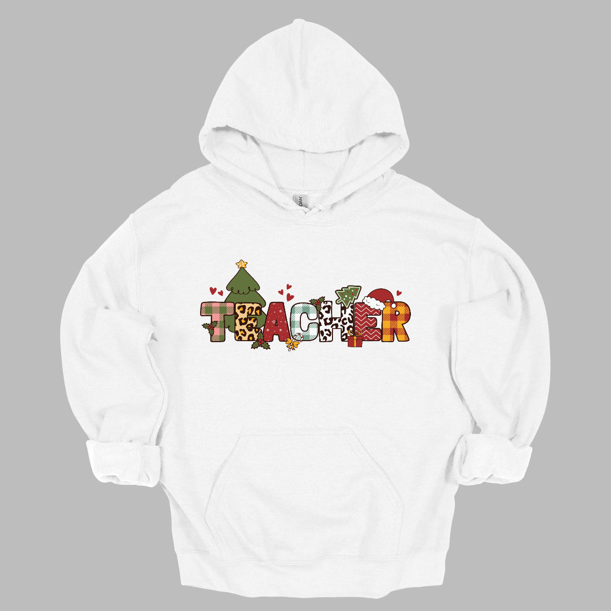 This eye-catching t-shirt boldly displays the word "TEACHER" in large block letters, each letter showcasing a unique style of print that adds a fun and creative flair. Behind the first "E," a cheerful Christmas tree adds a festive touch, while the second "E" is adorned with a cute Santa hat, making it even more playful. Shop Gorgeouswre.com