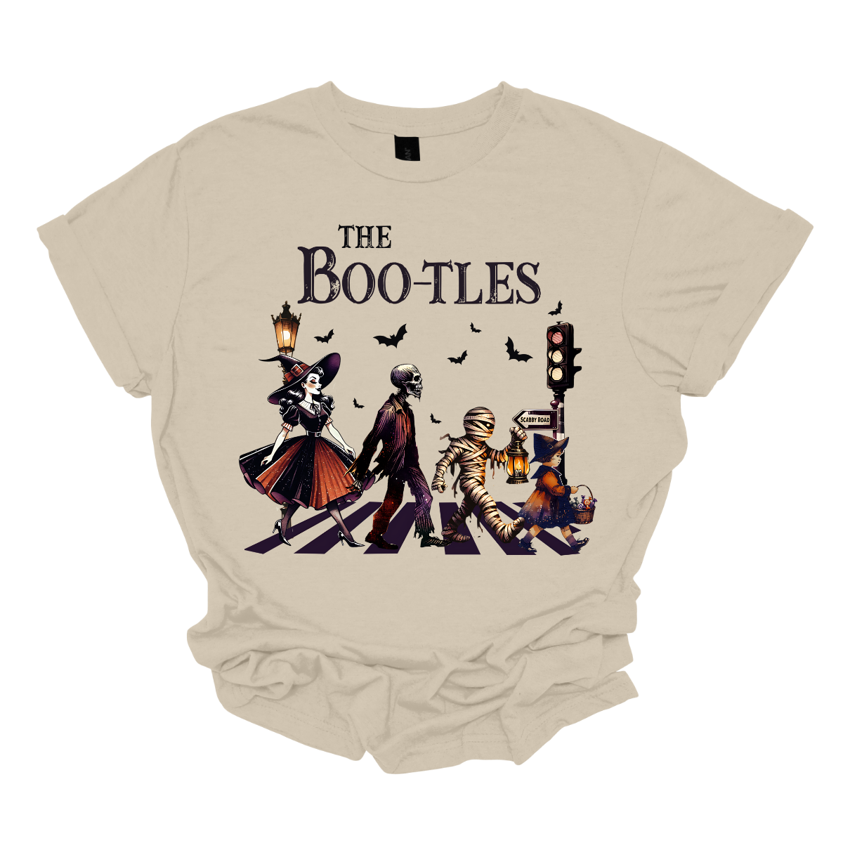 Step into a spooky twist on a classic with our 'Boot-les' tee! This Halloween-themed shirt takes inspiration from the iconic Abbey Road album cover and reimagines it with a creepy-cool lineup of Halloween characters. Picture this: a mischievous witch, a spooky skeleton, a creepy mummy, and a charming little witch, all crossing a spectral road in style. Shop at Gorgeousware.com