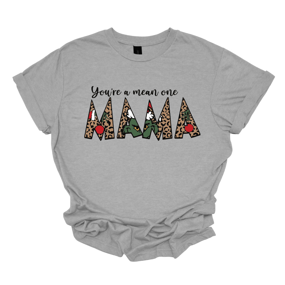 The phrase "You're a Mean One Mama" takes center stage, with "You're a Mean One" written in elegant black cursive font that flows beautifully across the fabric. The standout element is the word "Mama," which is rendered in bold, eye-catching letters. Each letter of "Mama" is filled with a quirky depiction of the Grinch, set against a vibrant cheetah print background. Shop Gorgeousware.com