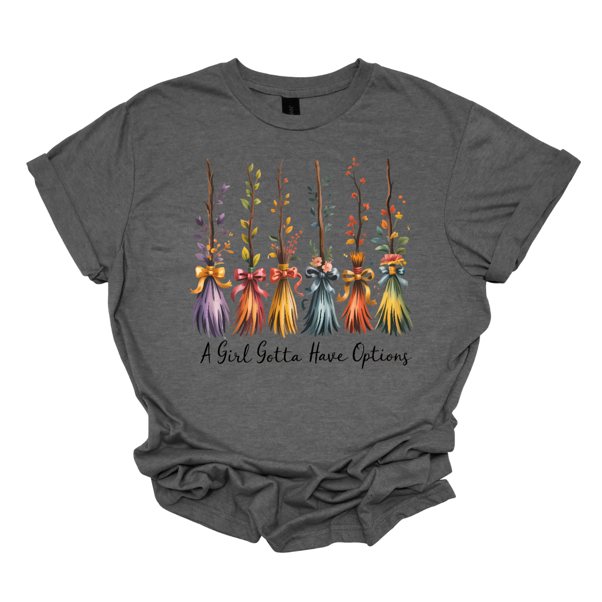 Add a little magic to your fall wardrobe with this fun and whimsical Halloween-inspired tee! The design features six wispy brooms lined up in playful autumn colors, each with its own unique charm. Beneath them, the phrase “A Girl Gotta Have Options” is written, making this shirt a cheeky and stylish nod to witchy fall vibes. Shop at Gorgeousware.com