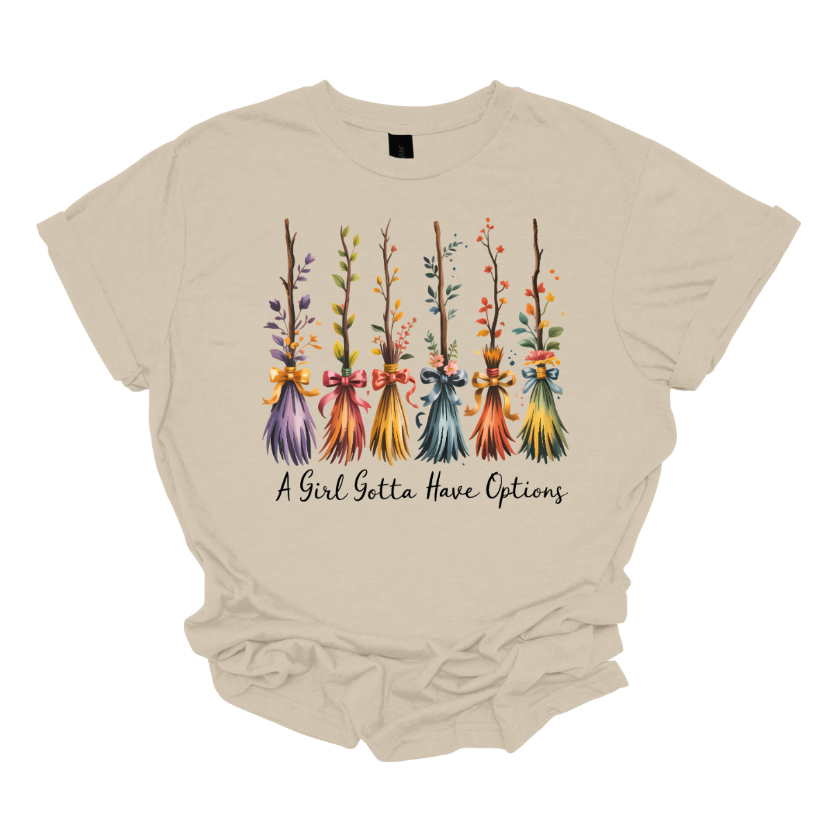 Add a little magic to your fall wardrobe with this fun and whimsical Halloween-inspired tee! The design features six wispy brooms lined up in playful autumn colors, each with its own unique charm. Beneath them, the phrase “A Girl Gotta Have Options” is written, making this shirt a cheeky and stylish nod to witchy fall vibes. Shop at Gorgeousware.com