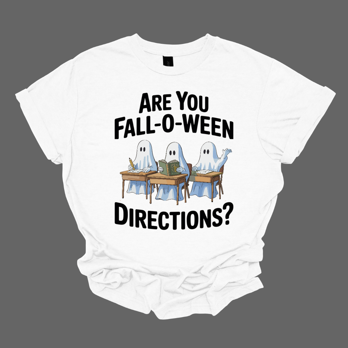 Bring some spooky fun into the classroom (or your everyday fall style) with this adorable Halloween graphic tee! 🎃👻 The design features three cute ghosts sitting at student desks — one writing with a pencil, one reading a book, and one raising their hand — paired with the playful phrase “Are you Fall-O-Ween Directions?” Shop at Gorgeousware.com