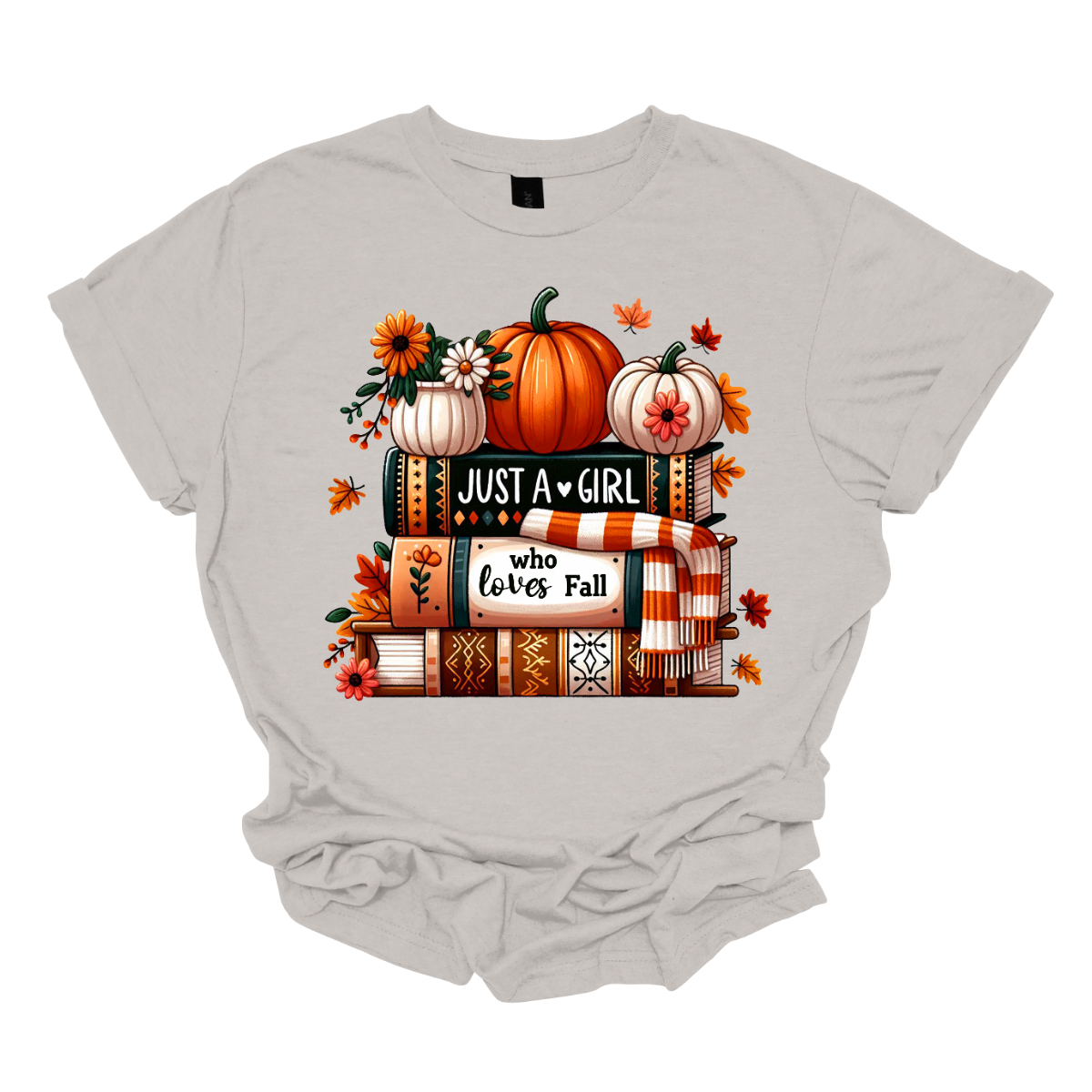 Bring cozy fall vibes to your wardrobe with this autumn-inspired graphic tee! The design features two pumpkins and a small pot of flowers perched on a stack of books with the spines reading “Just a Girl” and “Who Loves Fall.” An orange-and-white scarf wraps around the books while leaves gently fall, creating the perfect scene for autumn lovers. Shop at Gorgeousware.com