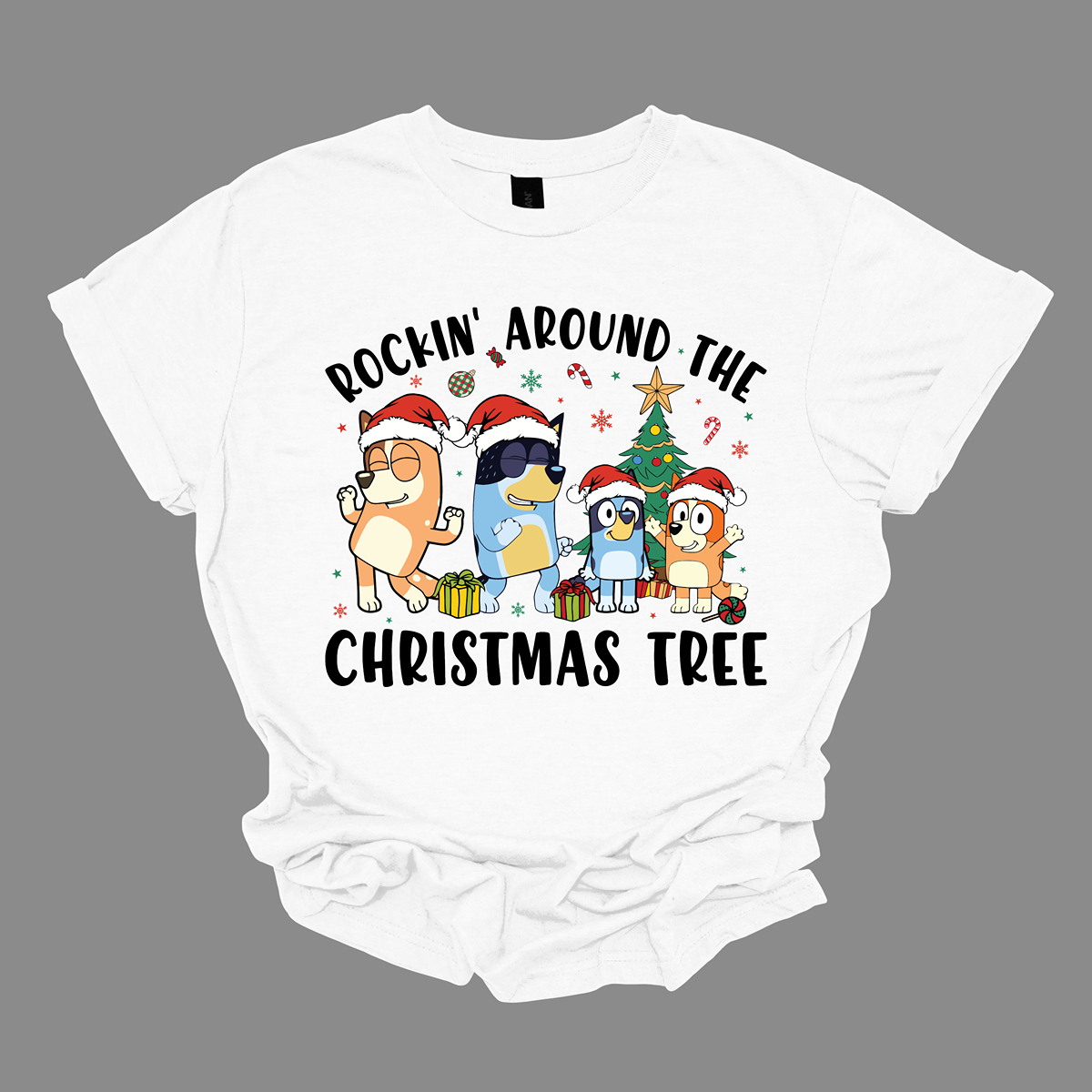 Celebrate the festive season with Bluey and her family in this heartwarming design! The beloved Bluey and her family are gathered around a beautifully decorated Christmas tree, joyfully rocking around the holiday cheer. The playful scene is filled with bright colors, festive ornaments, twinkling lights, and the spirit of togetherness. The phrase "Rockin' Around the Christmas Tree" arches over the design, capturing the fun and excitement of the holidays.