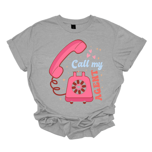 Make a stylish and witty statement with our 'Call My Agent' Valentine's Day T-shirt, featuring a vintage rotary telephone design. This tee is a playful nod to classic romance and communication, where the retro telephone adds a touch of nostalgia and charm. Crafted for comfort and infused with humor, this shirt is perfect for those who appreciate a clever and fashionable twist to the Valentine's Day theme.