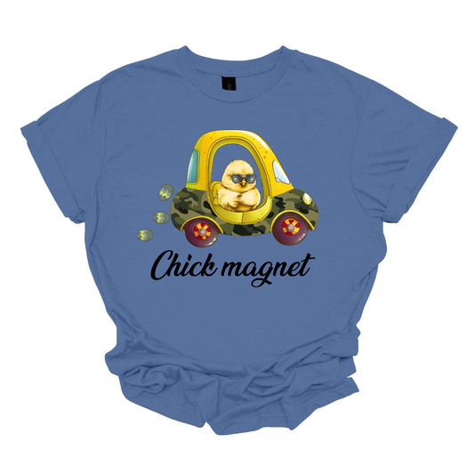 "Chick Magnet" - Drive into Easter with style in our adorable t-shirt featuring a charming little chick cruising in a cozy coupe, sunglasses on and a trail of Easter eggs in its wake. This playful design is sure to turn heads and spread smiles wherever you go, capturing the fun and excitement of the holiday season.  Shop at Gorgeousware.com