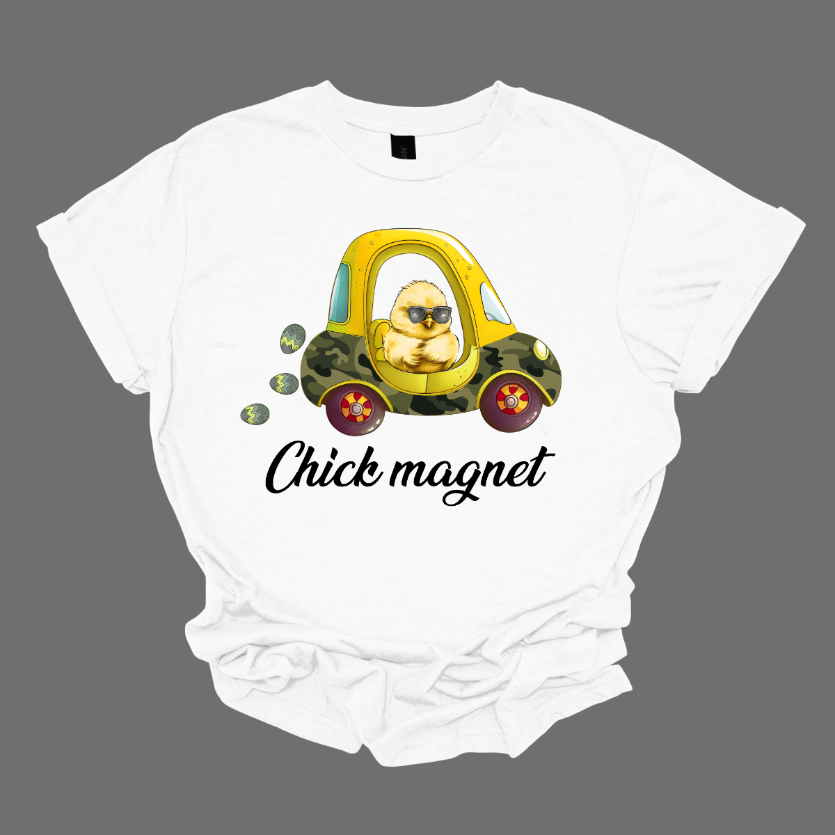 "Chick Magnet" - Drive into Easter with style in our adorable t-shirt featuring a charming little chick cruising in a cozy coupe, sunglasses on and a trail of Easter eggs in its wake. This playful design is sure to turn heads and spread smiles wherever you go, capturing the fun and excitement of the holiday season.  Shop at Gorgeousware.com