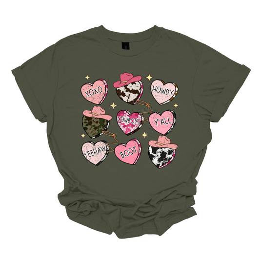 Introducing our "Country Conversation" Valentine's T-shirt – a delightful blend of rustic charm and heartfelt expressions. This shirt features a unique design adorned with hearts that incorporate lassos and cowgirl hats, creating a warm and Western-inspired atmosphere perfect for celebrating love in true country style.  The hearts on the shirt are creatively crafted with lassos encircling them, symbolizing the timeless act of roping in affection. Shop at Gorgeousware.com