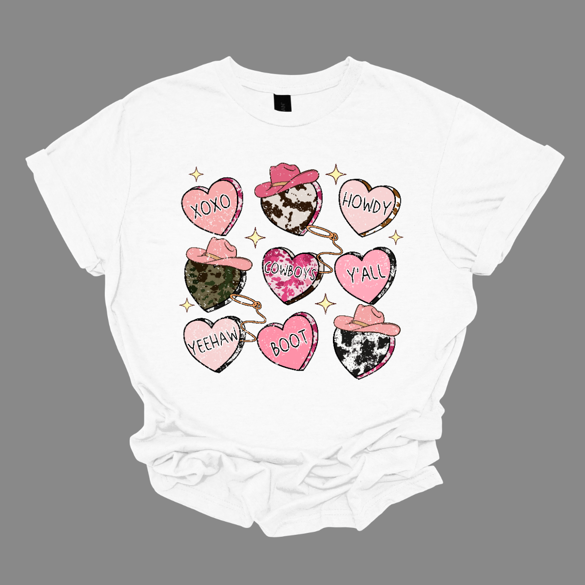 Introducing our "Country Conversation" Valentine's T-shirt – a delightful blend of rustic charm and heartfelt expressions. This shirt features a unique design adorned with hearts that incorporate lassos and cowgirl hats, creating a warm and Western-inspired atmosphere perfect for celebrating love in true country style. The hearts on the shirt are creatively crafted with lassos encircling them, symbolizing the timeless act of roping in affection. Shop at Gorgeousware.com