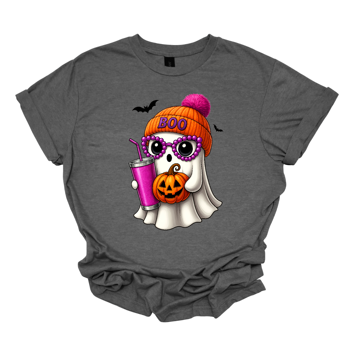 Bring on the spooky-cute vibes with this adorable fall tee! 👻🎃 The design features a sweet little ghost bundled up in an orange sock cap with a pink pom on top. The flipped brim of the hat reads “BOO” for a playful touch. This stylish ghost also sports purple reading glasses, holds a matching purple drink cup, and carries a tiny jack-o’-lantern bucket — ready for all the fall fun! Two little bats flutter in the background to complete the whimsical Halloween scene. Gorgeousware.com