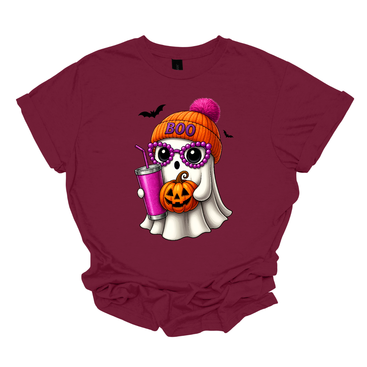 Bring on the spooky-cute vibes with this adorable fall tee! 👻🎃 The design features a sweet little ghost bundled up in an orange sock cap with a pink pom on top. The flipped brim of the hat reads “BOO” for a playful touch. This stylish ghost also sports purple reading glasses, holds a matching purple drink cup, and carries a tiny jack-o’-lantern bucket — ready for all the fall fun! Two little bats flutter in the background to complete the whimsical Halloween scene. Gorgeousware.com