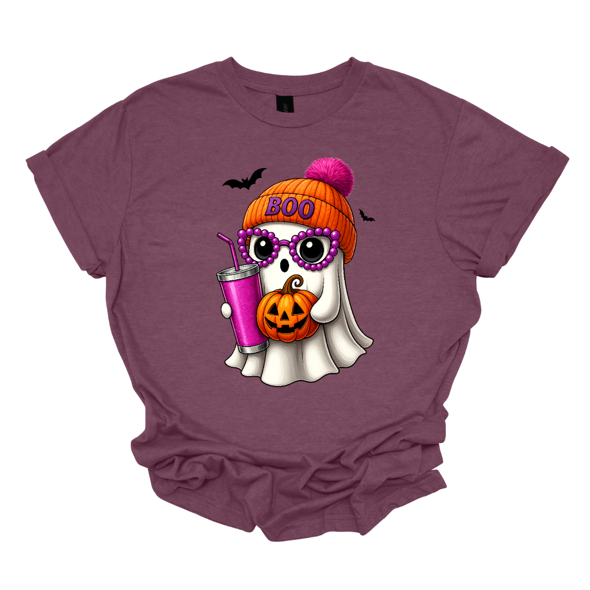 Bring on the spooky-cute vibes with this adorable fall tee! 👻🎃 The design features a sweet little ghost bundled up in an orange sock cap with a pink pom on top. The flipped brim of the hat reads “BOO” for a playful touch. This stylish ghost also sports purple reading glasses, holds a matching purple drink cup, and carries a tiny jack-o’-lantern bucket — ready for all the fall fun! Two little bats flutter in the background to complete the whimsical Halloween scene. Gorgeousware.com