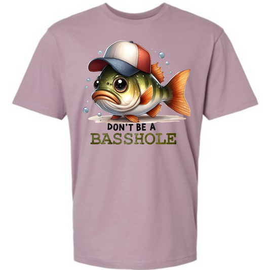 Make a splash with our “Don’t Be a Basshole” t-shirt! This cheeky design features a mischievous bass fish rocking a stylish baseball hat, delivering a hilarious twist on a classic phrase. The bold, playful text reminds everyone to keep things light and fun, while the fish adds a touch of unique character and charm. Made from soft, high-quality fabric, this shirt ensures comfort while you reel in compliments and laughs. Shop at Gorgeousware.com