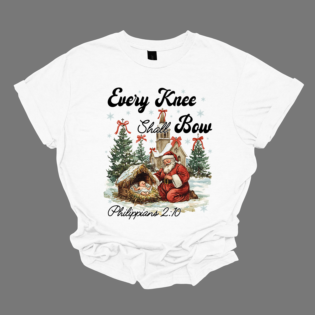 This festive and powerful apparel design features the phrase "Every Knee Shall Bow" in bold, elegant lettering, symbolizing the reverence and humility of the Christmas story. The artwork showcases Santa Claus, traditionally known for his joyful spirit, bowing down in awe before a humble manger that cradles baby Jesus. In the background, an old chapel stands as a symbol of faith, with evergreen trees adorned with festive bows, adding a touch of seasonal beauty and serenity.  Shop at Gorgeousware.com