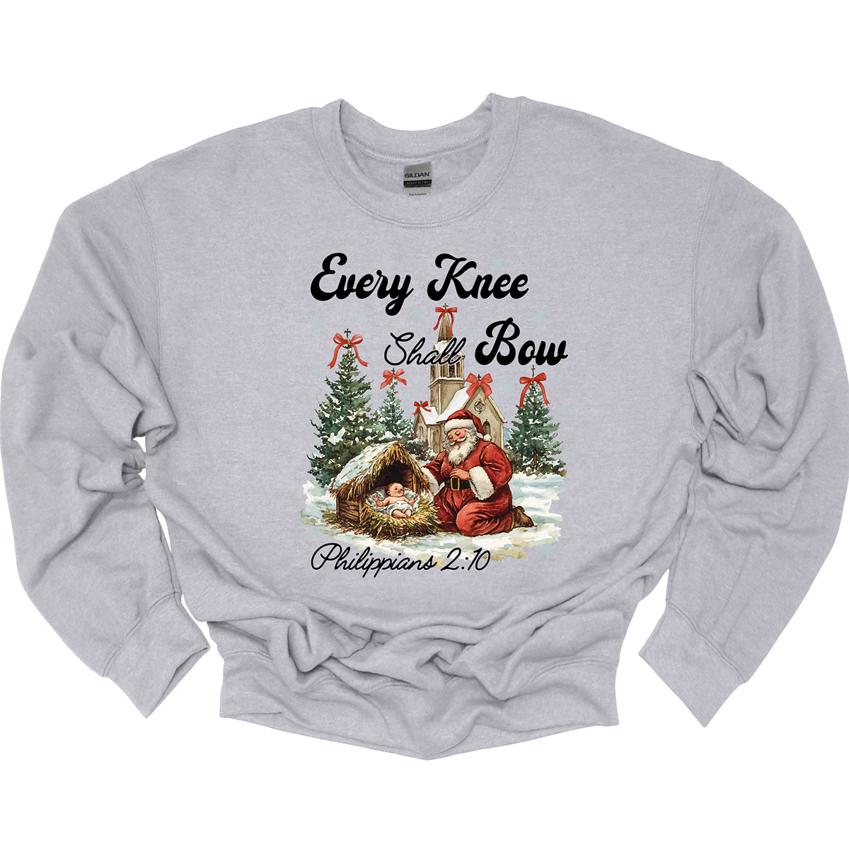 This festive and powerful apparel design features the phrase "Every Knee Shall Bow" in bold, elegant lettering, symbolizing the reverence and humility of the Christmas story. The artwork showcases Santa Claus, traditionally known for his joyful spirit, bowing down in awe before a humble manger that cradles baby Jesus. In the background, an old chapel stands as a symbol of faith, with evergreen trees adorned with festive bows, adding a touch of seasonal beauty and serenity.  Shop at Gorgeousware.com