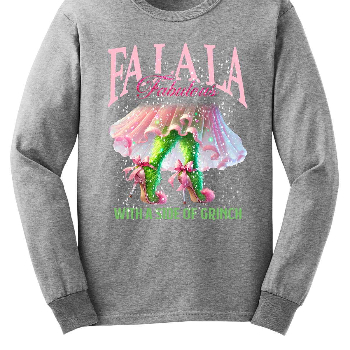 The design features a playful and festive take on the Grinch character with a stylish twist. The phrase "Fa La La Fabulous" is at the top in a fun, cursive font with a bouncy, holiday-inspired feel. The word "Fabulous" stands out in bold, glamorous lettering with subtle sparkles, giving it a chic vibe. Below, the Grinch is shown with her girly green legs, styled in light pink high heels adorned with oversized bows at the back, adding a sweet and fashionable touch. Shop at Gorgeousware.com