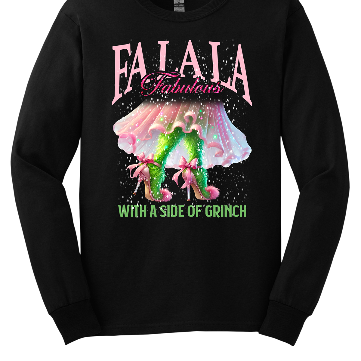 The design features a playful and festive take on the Grinch character with a stylish twist. The phrase "Fa La La Fabulous" is at the top in a fun, cursive font with a bouncy, holiday-inspired feel. The word "Fabulous" stands out in bold, glamorous lettering with subtle sparkles, giving it a chic vibe. Below, the Grinch is shown with her girly green legs, styled in light pink high heels adorned with oversized bows at the back, adding a sweet and fashionable touch. Shop at Gorgeousware.com