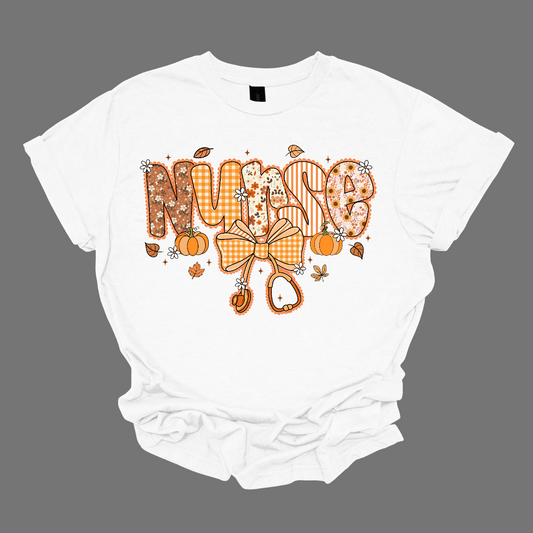 White t-shirt with 'Nurse' design featuring a bow and pumpkins on a gray background