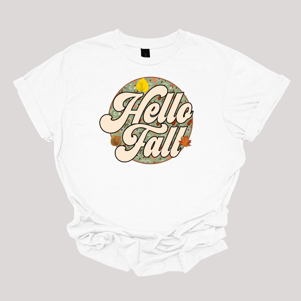 Embrace the cozy vibes of autumn with our "Hello Fall" t-shirt! This vintage-inspired design features a charming retro font that welcomes the season with warmth and style. The phrase "Hello Fall" is nestled in the center of a circular frame, surrounded by a delightful fall-themed backdrop. Shop at Gorgeousware.com.