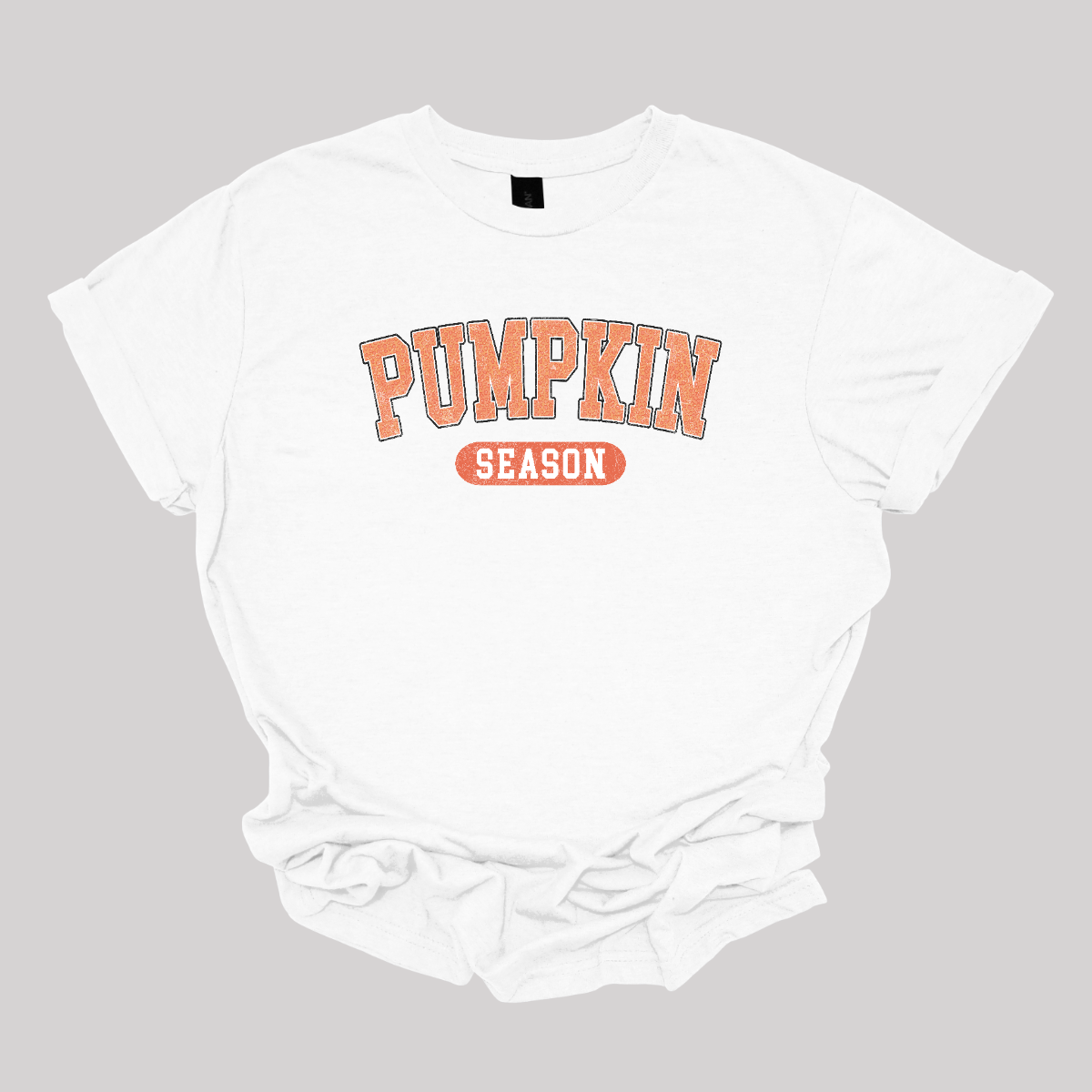 The t-shirt features a clean and eye-catching design with the phrase "Pumpkin Season" prominently displayed. The word "Pumpkin" is rendered in bold, vibrant orange letters, making it the focal point of the design. This bright orange stands out against the shirt's background, capturing the essence of autumn. The word "Season" is styled in crisp white letters, providing a sharp contrast to the bold orange of "Pumpkin." Shop Gorgeousware.com