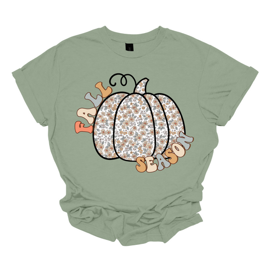 Celebrate the beauty of autumn with our "Fall Season" t-shirt! This enchanting design features the words "Fall Season" in a stylish, easy-to-read font, perfectly complemented by a unique pumpkin illustration. The pumpkin is adorned with a soft floral pattern, blending seasonal charm with a touch of whimsical elegance.  Shop at Gorgeousware.com