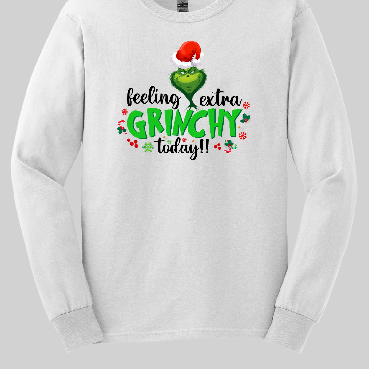 This T-shirt design exudes festive cheer and playful humor with its vibrant and eye-catching elements. The front of the shirt features the phrase, "Feeling extra grinchy today!!" prominently displayed in a fun and engaging. Shop Gorgeousware.com