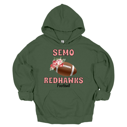 This SEMO hoodie features bold pink SEMO Redhawks lettering across the front, making your pride stand out in eye-catching fashion. A detailed football is accented with delicate flowers adds a unique, feminine twist, while the finishing touch of bold black Football lettering ties the look together. This design blends fierce Redhawk energy with a soft, stylish edge.
Shop at Gorgeousware.com today!


