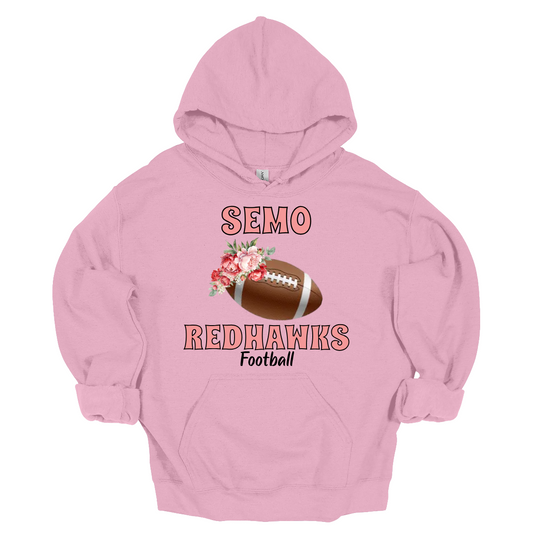 Let your young Redhawk fan shine with this stylish SEMO hoodie in youth sizes! Featuring SEMO Redhawks in bold pink lettering, this piece stands out with a unique football accented by delicate floral details on one side, bringing a touch of charm to game day gear. The design is finished with “Redhawks” in sleek black lettering, balancing bold team spirit with a soft, feminine edge.
Shop at Gorgeousware.com today!
