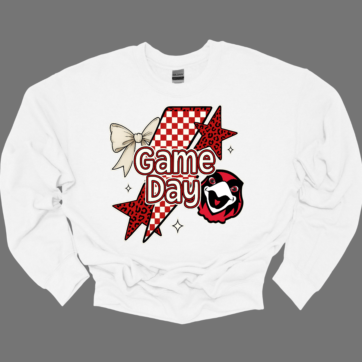Bring the energy of the stands to your style with the Game Day Rowdy SEMO crewneck and hoodie! This eye-catching piece features striking shooting stars that celebrates SEMO’s unstoppable momentum. At the heart of the design, the fearless Redhawk, symbolizing strength and school pride. A playful croquette bow adds a unique touch of flair, while the powerful “Game Day” lettering in crisp white overlays the design—reminding everyone you’re ready to cheer loud and proud.
Shop at Gorgeouswear.com today!
