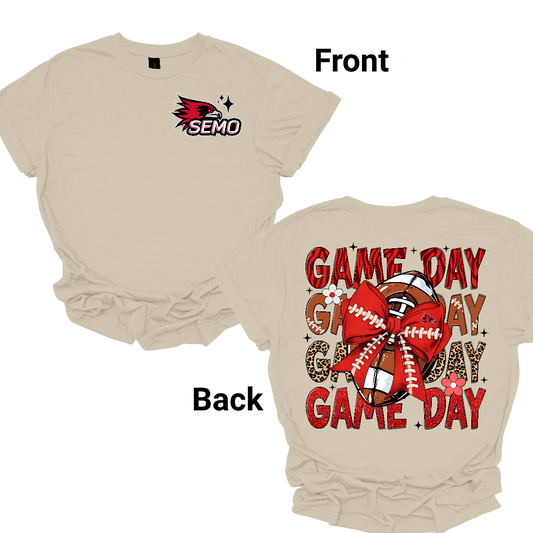 This bold SEMO short-sleeved tee packs serious team spirit into every detail. The front has a ferocious Redhawk graphic paired with SEMO in bold white lettering over the left chest. The back has “Game Day” repeated in eye catching animal print and football-lace lettering. A football wrapped in a red bow steals the spotlight, complete with football-lace details and a small Redhawk perched on the bow. Shop at Gorgeousware.com today!
