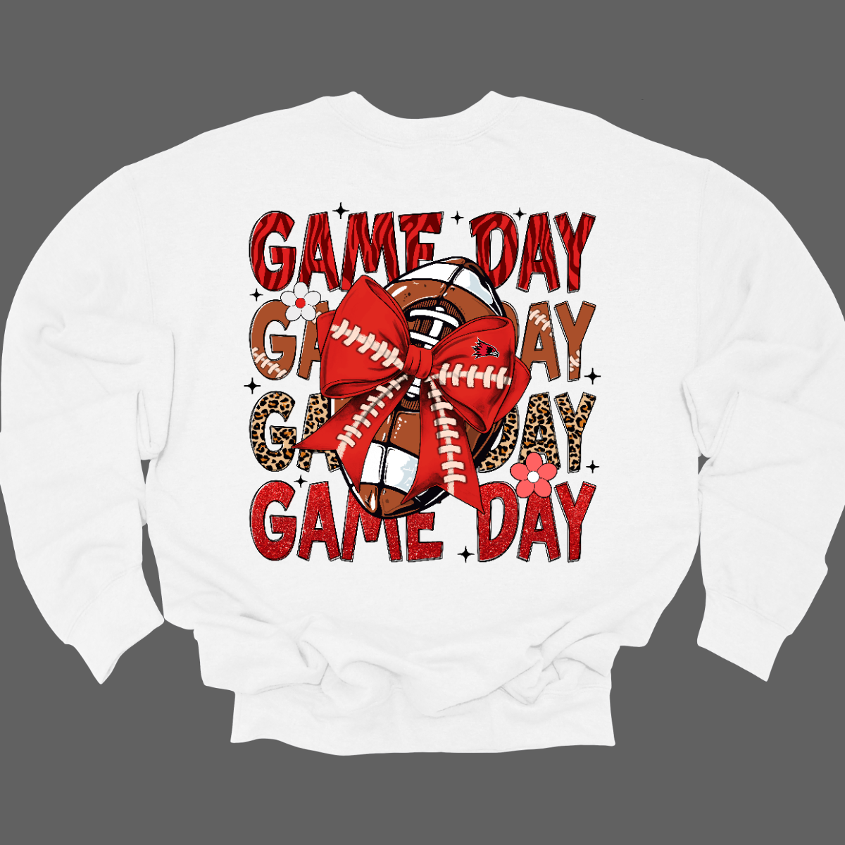 This bold SEMO shirt packs serious team spirit into every detail. The front has a ferocious Redhawk graphic paired with SEMO in bold white lettering over the left chest. The back has “Game Day” repeated in eye catching animal print and football-lace lettering. A football wrapped in a red bow steals the spotlight, complete with football-lace details and a small Redhawk perched on the bow. Go Redhawks! 
Shop at Gorgeousware.com today!
