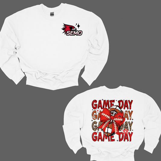 This bold SEMO shirt packs serious team spirit into every detail. The front has a ferocious Redhawk graphic paired with SEMO in bold white lettering over the left chest. The back has “Game Day” repeated in eye catching animal print and football-lace lettering. A football wrapped in a red bow steals the spotlight, complete with football-lace details and a small Redhawk perched on the bow. Go Redhawks! 
Shop at Gorgeousware.com today!