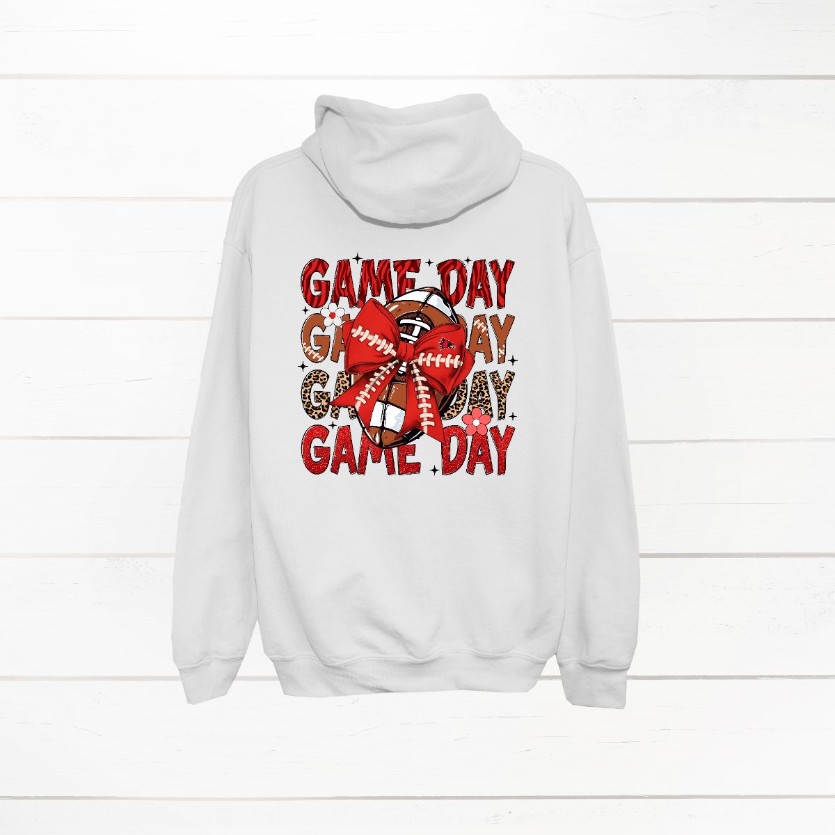 This bold SEMO shirt packs serious team spirit into every detail. The front has a ferocious Redhawk graphic paired with SEMO in bold white lettering over the left chest. The back has “Game Day” repeated in eye catching animal print and football-lace lettering. A football wrapped in a red bow steals the spotlight, complete with football-lace details and a small Redhawk perched on the bow. Go Redhawks! 
Shop at Gorgeousware.com today!
