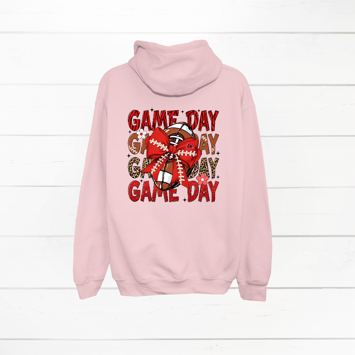 This bold SEMO shirt packs serious team spirit into every detail. The front has a ferocious Redhawk graphic paired with SEMO in bold white lettering over the left chest. The back has “Game Day” repeated in eye catching animal print and football-lace lettering. A football wrapped in a red bow steals the spotlight, complete with football-lace details and a small Redhawk perched on the bow. Go Redhawks! 
Shop at Gorgeousware.com today!
