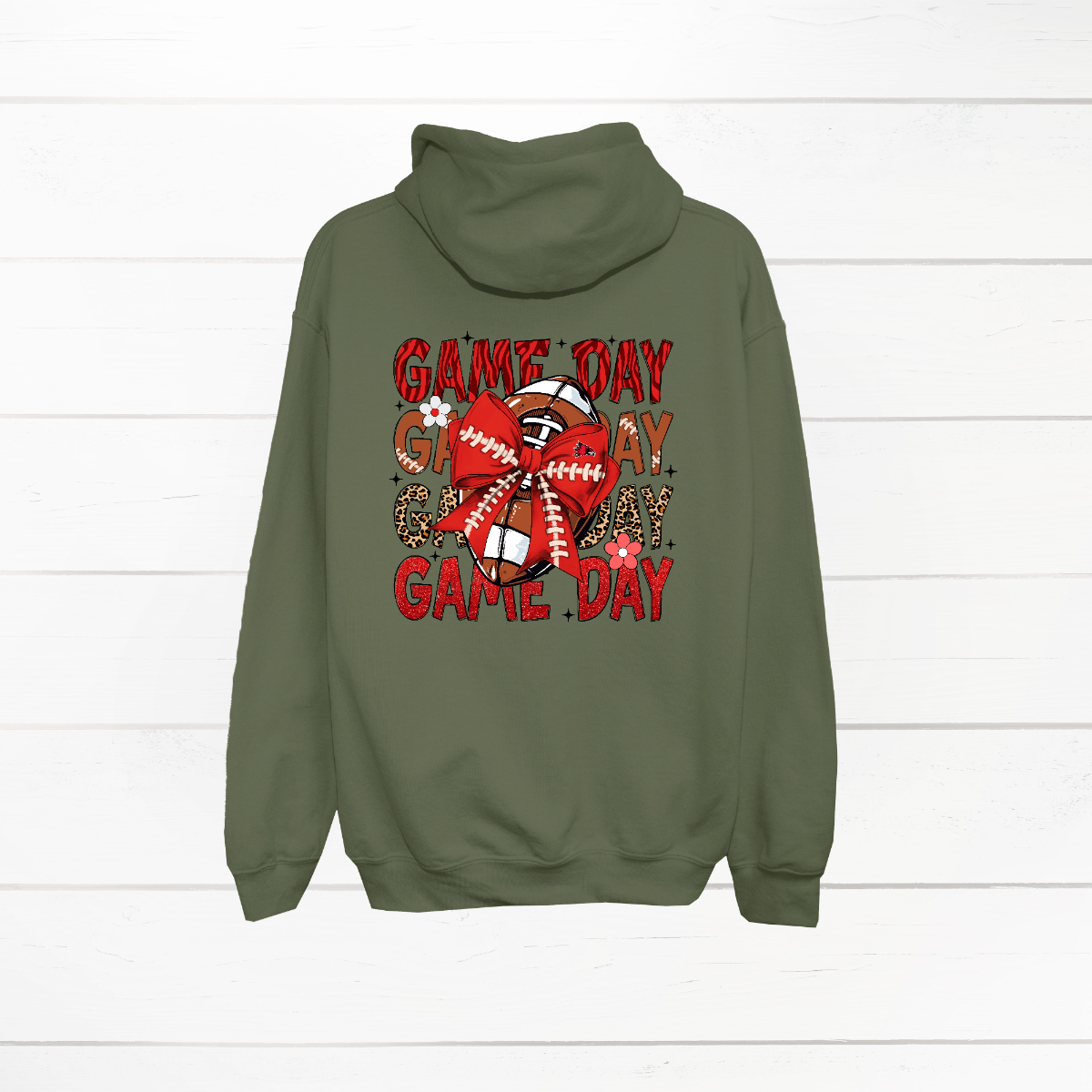 This bold SEMO shirt packs serious team spirit into every detail. The front has a ferocious Redhawk graphic paired with SEMO in bold white lettering over the left chest. The back has “Game Day” repeated in eye catching animal print and football-lace lettering. A football wrapped in a red bow steals the spotlight, complete with football-lace details and a small Redhawk perched on the bow. Go Redhawks! 
Shop at Gorgeousware.com today!

