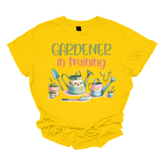This adorable "Gardener In Training" shirt is perfect for little green thumbs! Featuring a fun, colorful design, it lets everyone know that your child is ready to dig, plant, and grow their way to gardening greatness. With its playful message and soft, comfortable fabric, this shirt is perfect for outdoor adventures, school activities, or helping out in the garden. A great gift for aspiring gardeners who are eager to get their hands dirty!  Shop Gorgeouseware.com