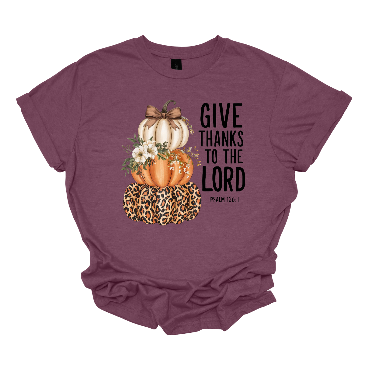 Celebrate the season of gratitude with this beautiful fall graphic tee! The design features a charming stack of three pumpkins — cream, orange, and leopard print — topped with a bow and accented with soft cream-colored flowers between the second and third pumpkin. To the right, in bold lettering, the verse “Give thanks to the Lord – Psalms 136:1” is displayed, making this the perfect faith-inspired fall shirt. Shop at Gorgeousware.com