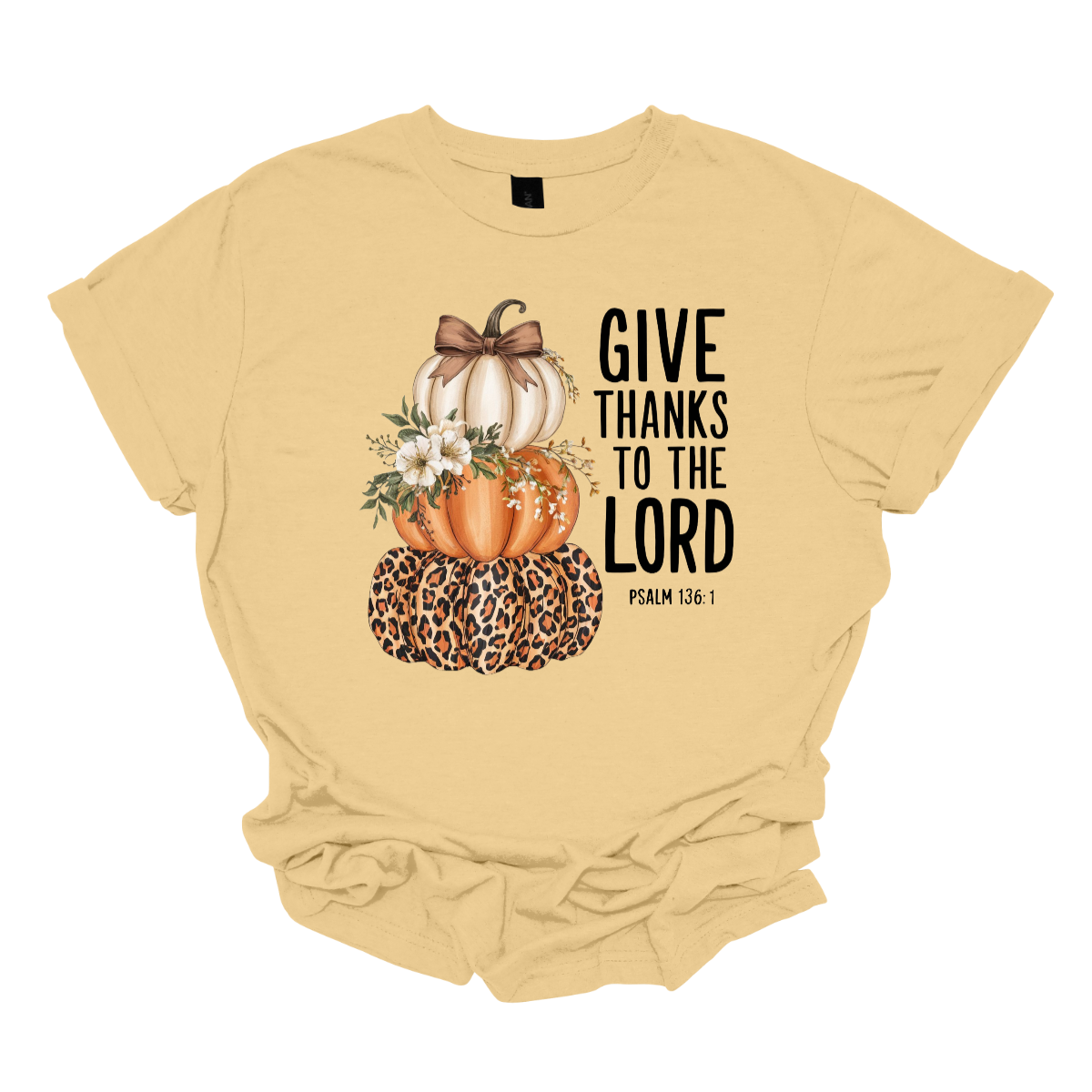 Celebrate the season of gratitude with this beautiful fall graphic tee! The design features a charming stack of three pumpkins — cream, orange, and leopard print — topped with a bow and accented with soft cream-colored flowers between the second and third pumpkin. To the right, in bold lettering, the verse “Give thanks to the Lord – Psalms 136:1” is displayed, making this the perfect faith-inspired fall shirt. Shop at Gorgeousware.com