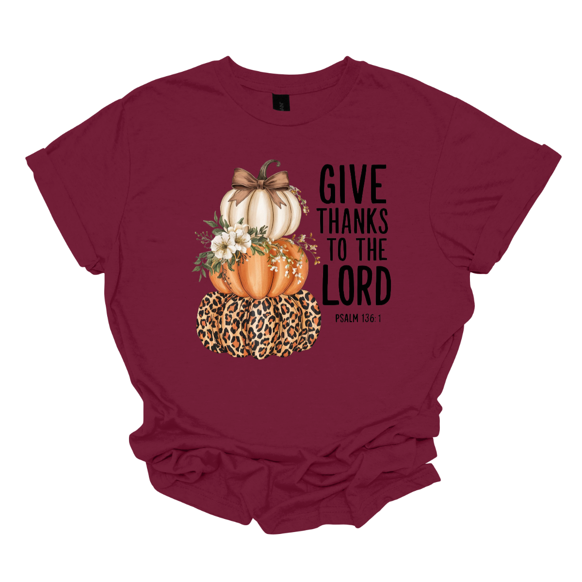 Celebrate the season of gratitude with this beautiful fall graphic tee! The design features a charming stack of three pumpkins — cream, orange, and leopard print — topped with a bow and accented with soft cream-colored flowers between the second and third pumpkin. To the right, in bold lettering, the verse “Give thanks to the Lord – Psalms 136:1” is displayed, making this the perfect faith-inspired fall shirt. Shop at Gorgeousware.com