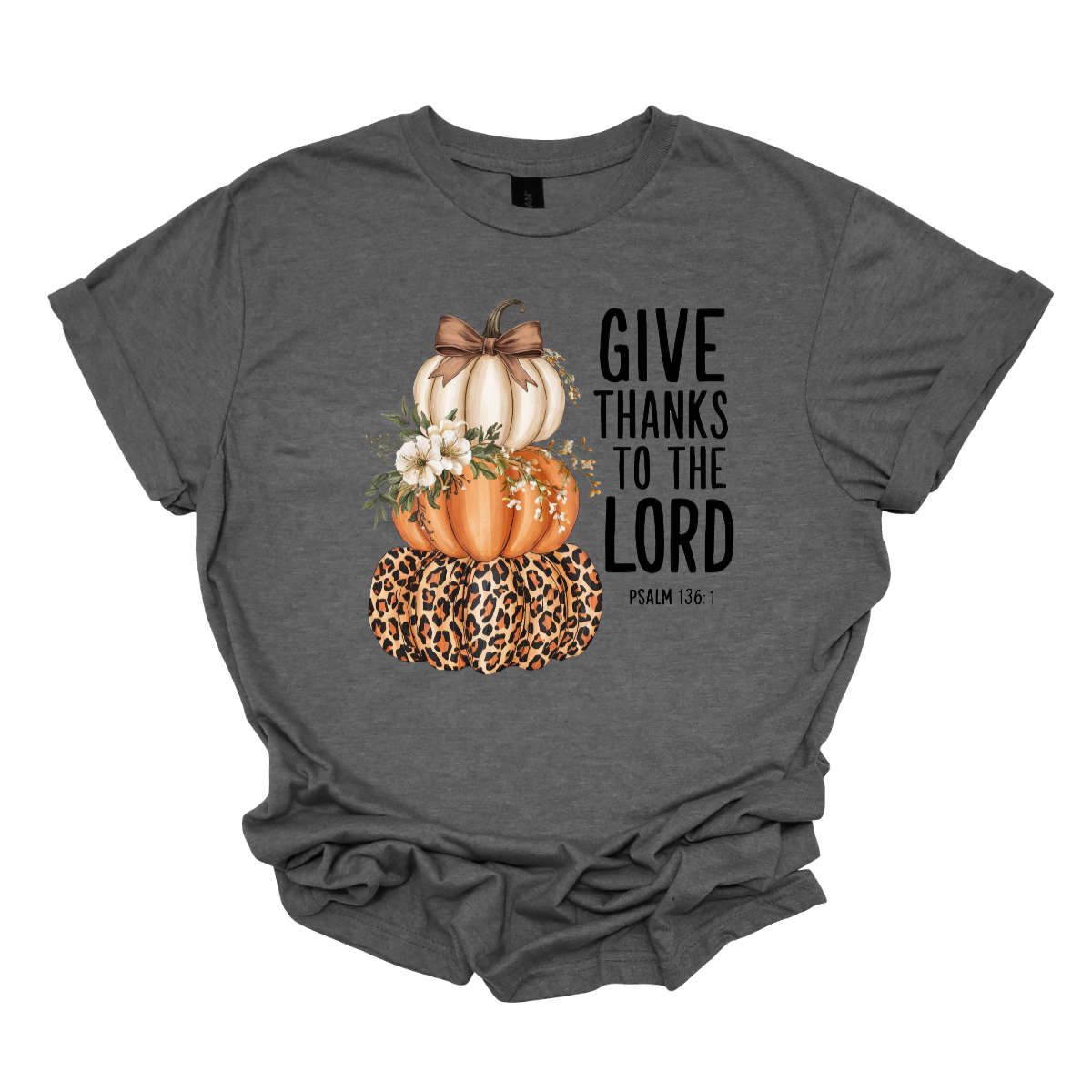 Celebrate the season of gratitude with this beautiful fall graphic tee! The design features a charming stack of three pumpkins — cream, orange, and leopard print — topped with a bow and accented with soft cream-colored flowers between the second and third pumpkin. To the right, in bold lettering, the verse “Give thanks to the Lord – Psalms 136:1” is displayed, making this the perfect faith-inspired fall shirt. Shop at Gorgeousware.com