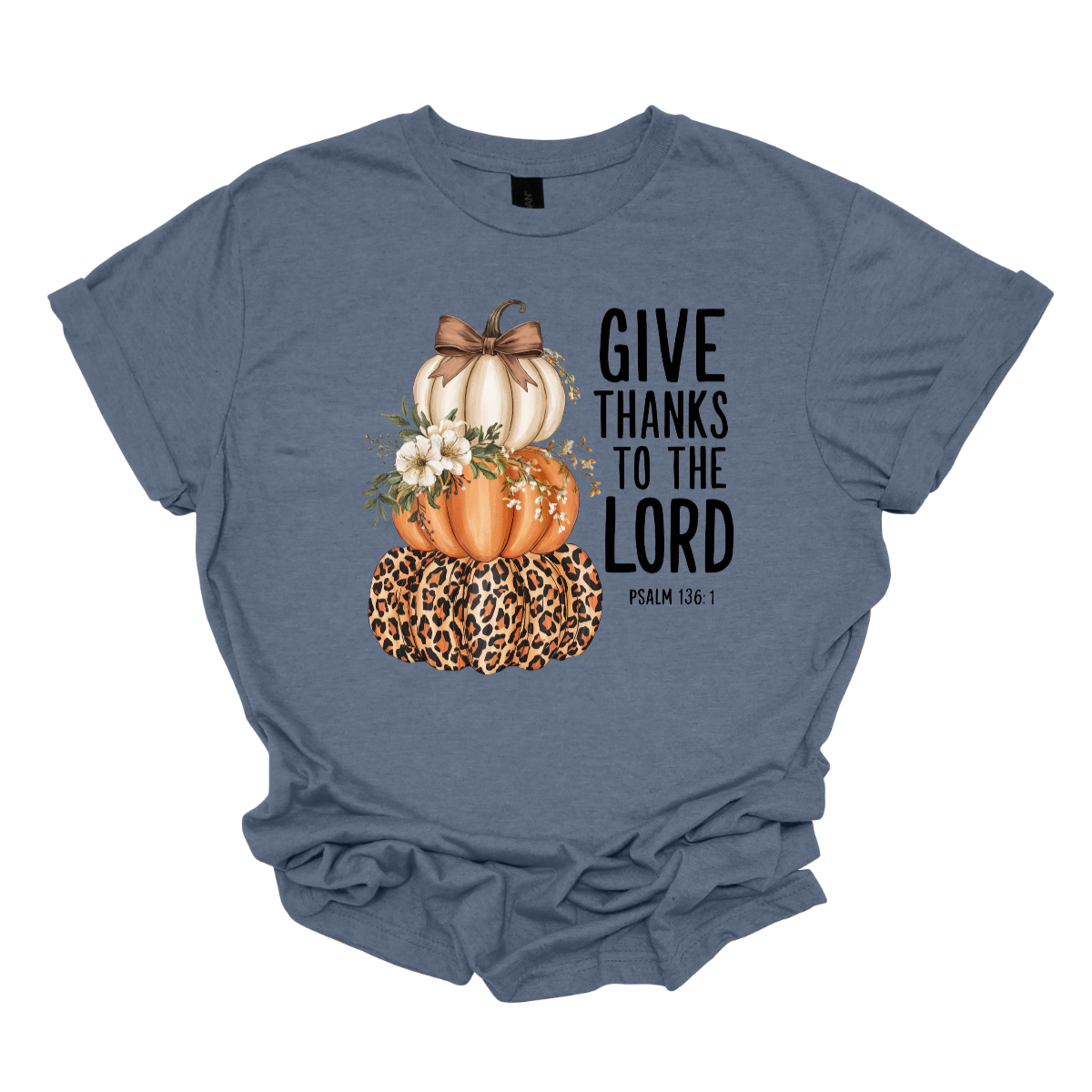 Celebrate the season of gratitude with this beautiful fall graphic tee! The design features a charming stack of three pumpkins — cream, orange, and leopard print — topped with a bow and accented with soft cream-colored flowers between the second and third pumpkin. To the right, in bold lettering, the verse “Give thanks to the Lord – Psalms 136:1” is displayed, making this the perfect faith-inspired fall shirt. Shop at Gorgeousware.com