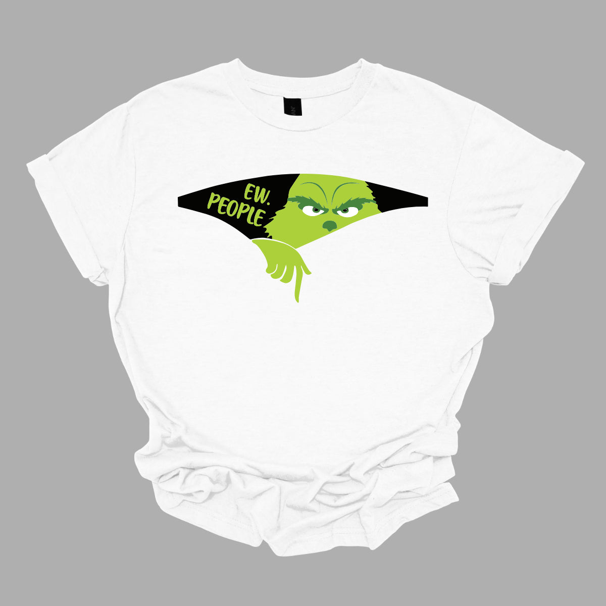 This T-shirt features a playful and eye-catching design centered around a cut-out illusion. The shirt showcases a dynamic cut-out effect, creating the appearance that a section of the fabric has been torn away. Through this cut-out, the Grinch is depicted in vivid, cartoonish detail, as though he’s emerging from the hole saying "Ew. People". Shop Gorgeousware.com