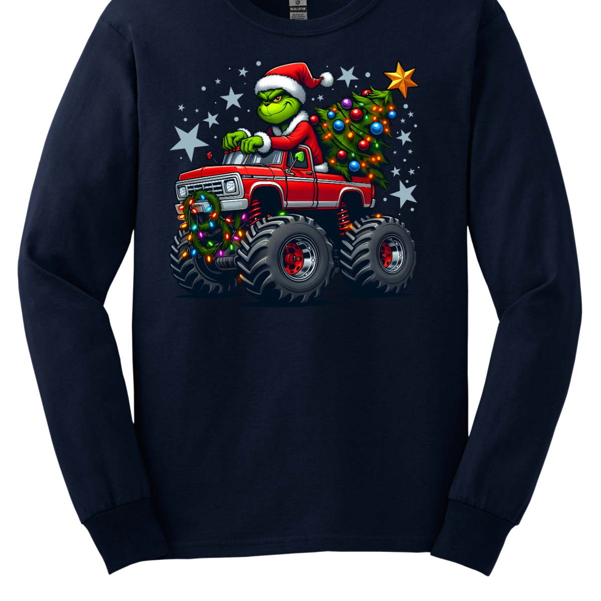 Navy blue long-sleeve shirt with a graphic of a Grinch driving a monster truck with a Christmas tree, on a white background. Shop at Gorgeousware.com