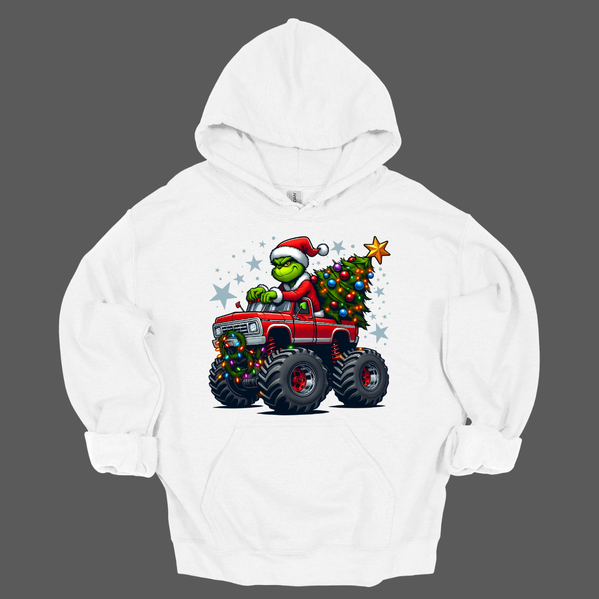 White hoodie with a graphic of a character driving a monster truck with a Christmas tree, on a gray background. Shop at Gorgeousware.com