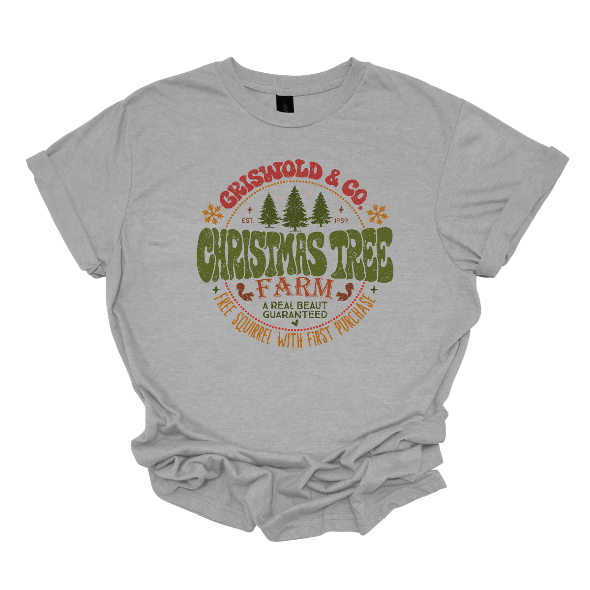 This festive t-shirt captures the spirit of holiday fun with a design inspired by classic Christmas cheer. The shirt features the words “Christmas Tree Farm” prominently displayed, with “Christmas Tree” in vibrant green bubble letters that pop with playful energy.Encircling this central text is “Griswold &amp; CO.,” giving it a nostalgic nod to the iconic family from holiday movie lore. Surrounding the main text are memorable quotes from the movie. Shop Gorgeousware.com