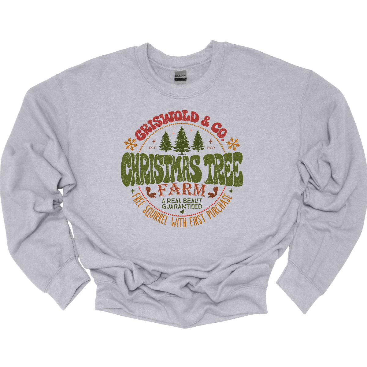 This festive t-shirt captures the spirit of holiday fun with a design inspired by classic Christmas cheer. The shirt features the words “Christmas Tree Farm” prominently displayed, with “Christmas Tree” in vibrant green bubble letters that pop with playful energy.Encircling this central text is “Griswold &amp; CO.,” giving it a nostalgic nod to the iconic family from holiday movie lore. Surrounding the main text are memorable quotes from the movie. Shop Gorgeousware.com