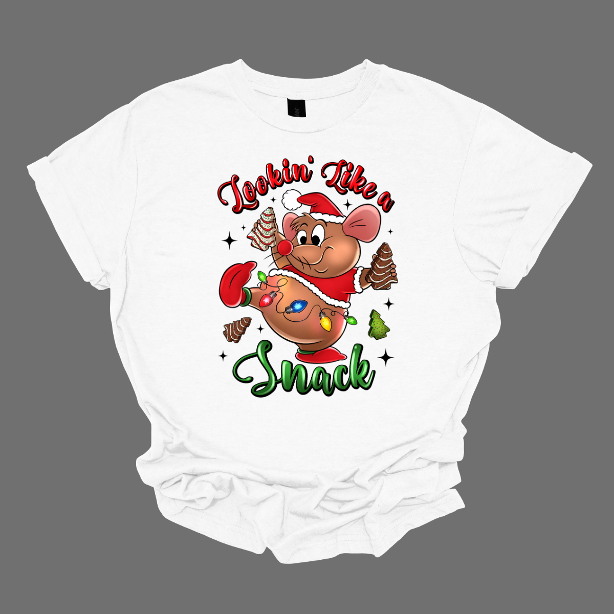 White t-shirt with a cartoon mouse, Gus Gus, holding a Christmas snack and text 'Lookin' Like a Snack' on a grey background. Shop at Gorgeousware.com