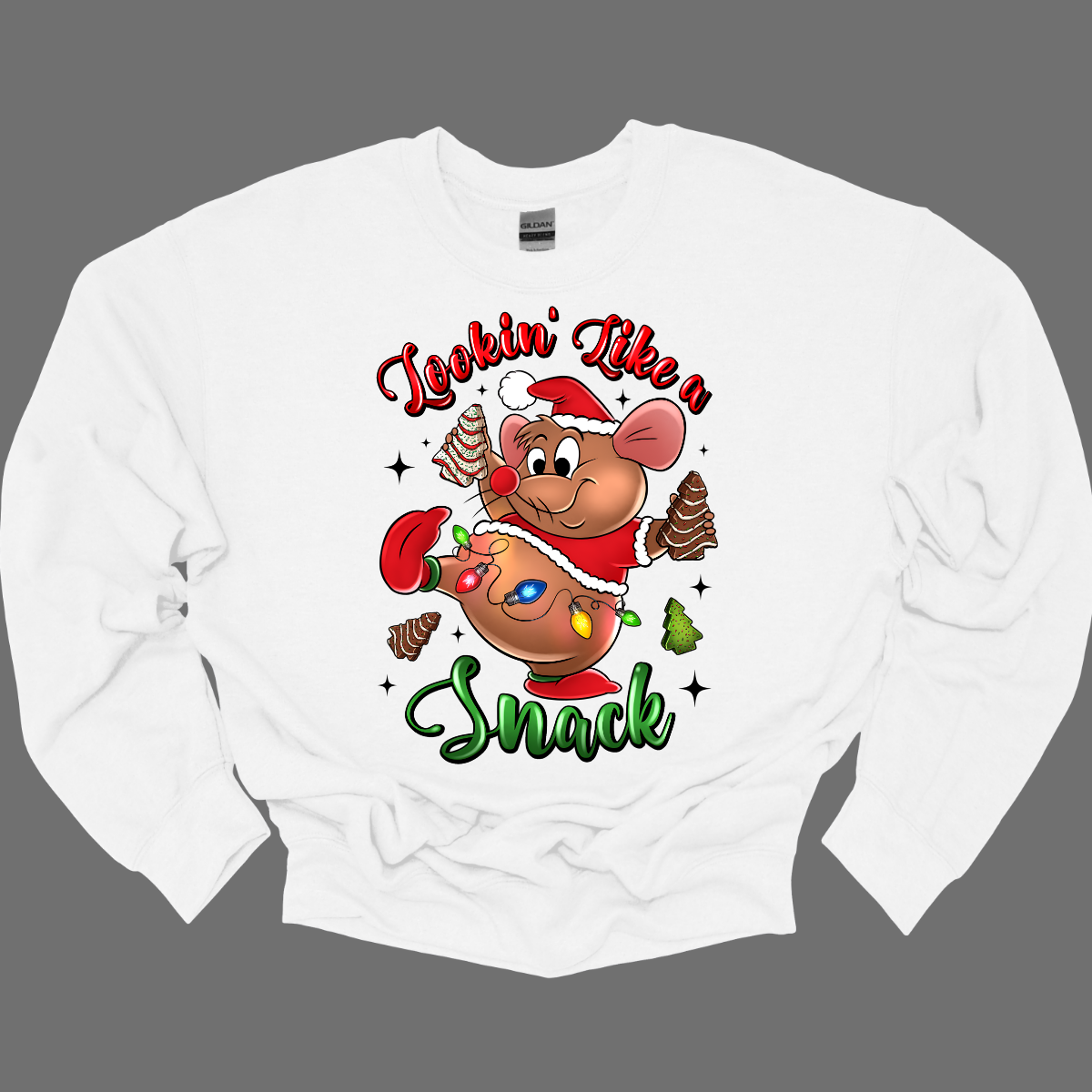 White crewneck sweatshirt with a cartoon mouse, Gus Gus, holding a Christmas snack and text 'Lookin' Like a Snack' on a grey background. Shop at Gorgeousware.com