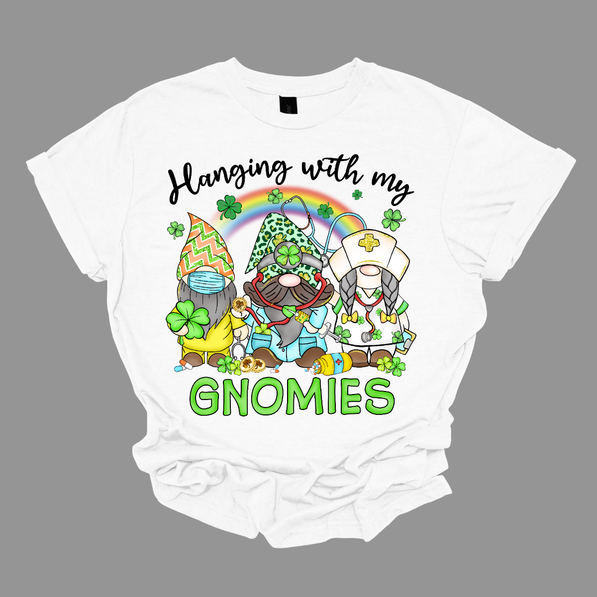 ☘️ "Hanging with my Gnomies" St. Patrick's Day T-shirt: A Tribute to Healthcare Heroes! ☘️  Get into the St. Patrick's Day spirit with our heartwarming and whimsical tee featuring three charming gnomes dressed in healthcare worker apparel, complete with stethoscopes. It's a delightful fusion of Irish cheer and appreciation for the incredible work of our healthcare heroes. Shop at Gorgeousware.com today!